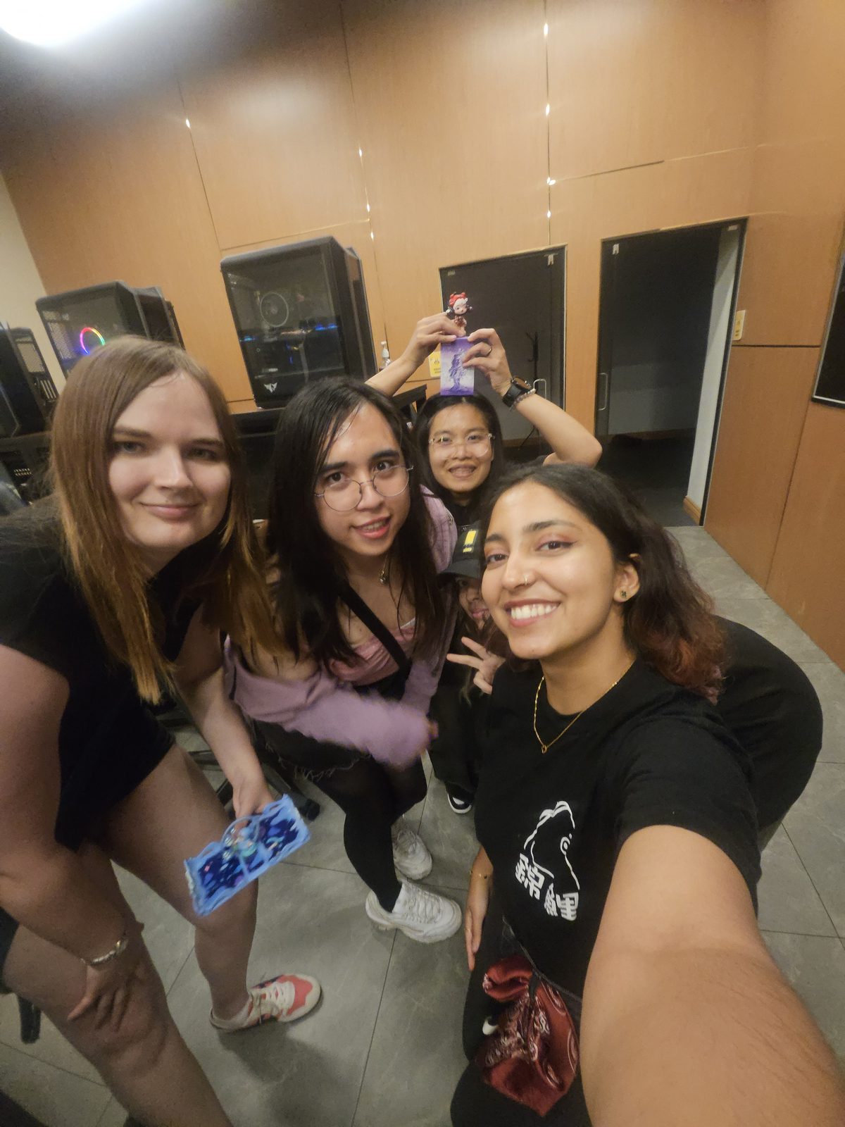 Friends taking a group selfie at a games social